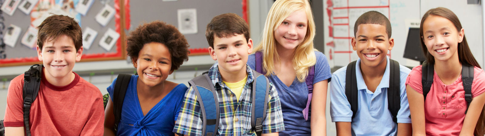 middle school students sitting shoulder to shoulder