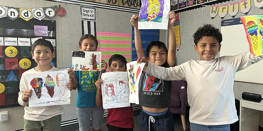 Expanded Learning students proudly display their summer art projects.