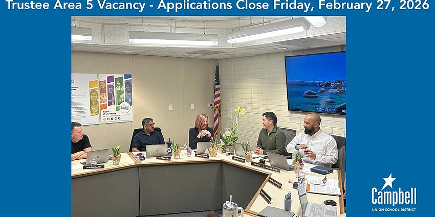 Photo of board members interacting with one another during a board meeting.