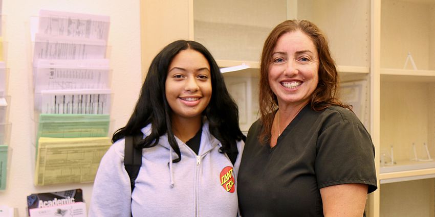 mom and daughter smiling at school