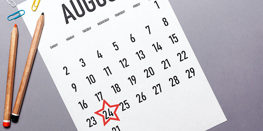 august calendar with red star on 24