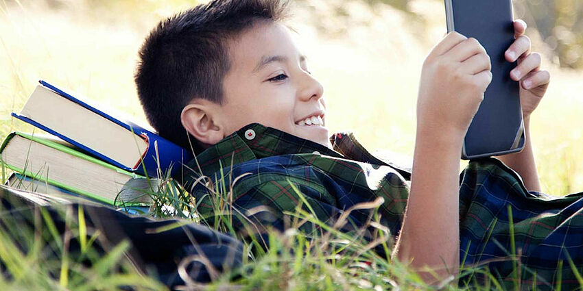 boy with books smiling
