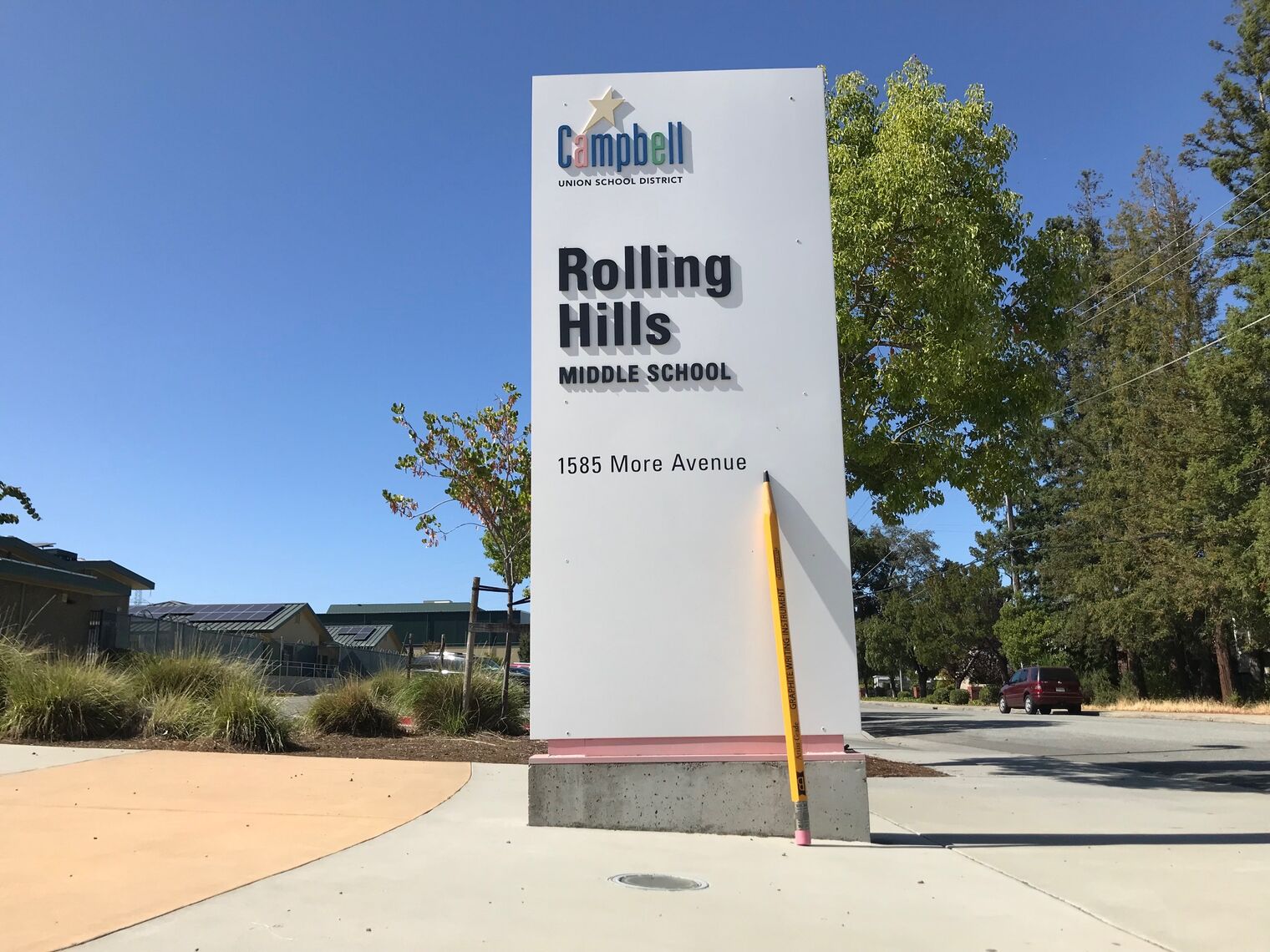 pencil leaning against rolling hills sign