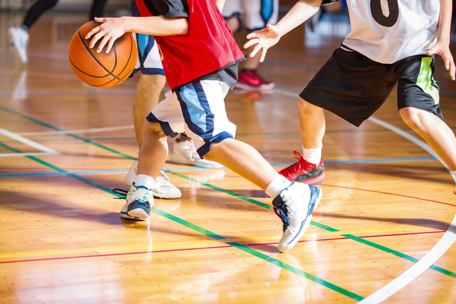 legs of boys playing basketball