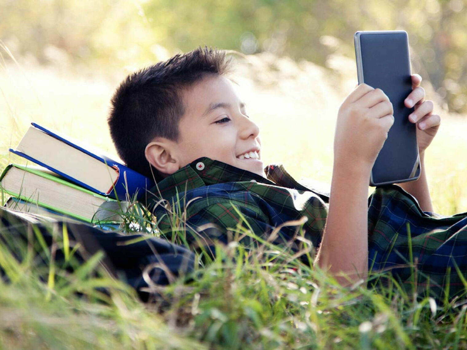 boy with books smiling